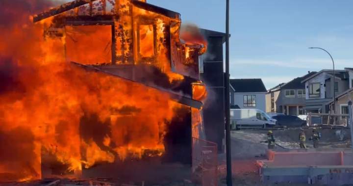 Firefighters from three departments help battle huge house fire east of Calgary
