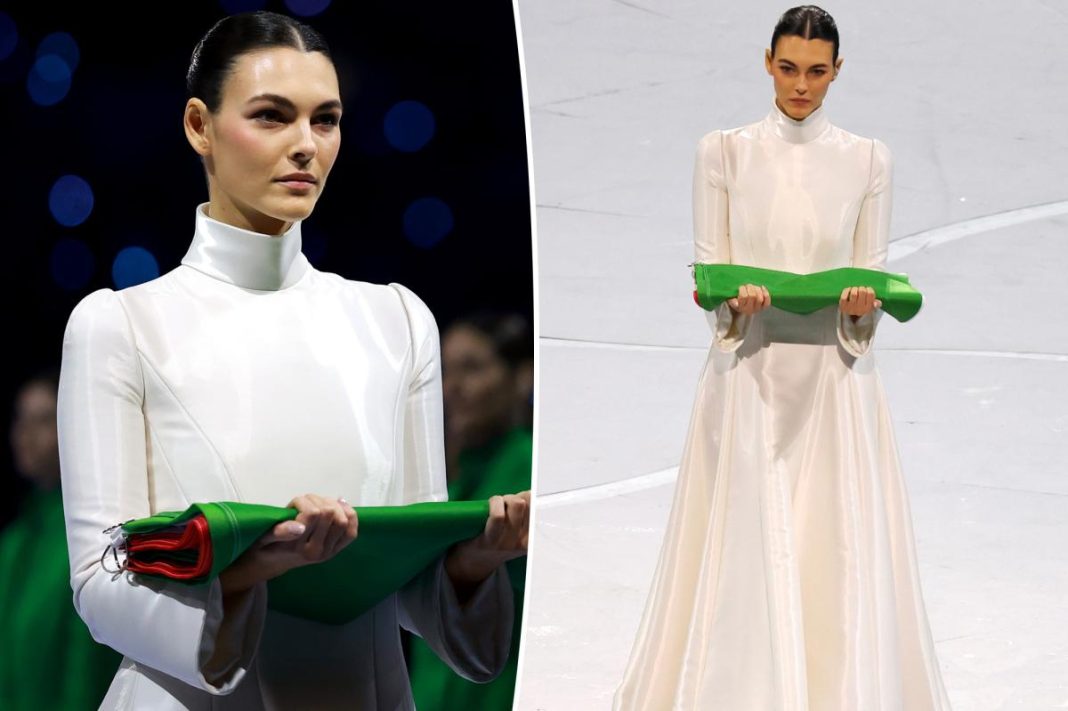 Supermodel Vittoria Ceretti carries the Italian flag in crisp white Armani during Winter Olympics 2026 opening ceremony