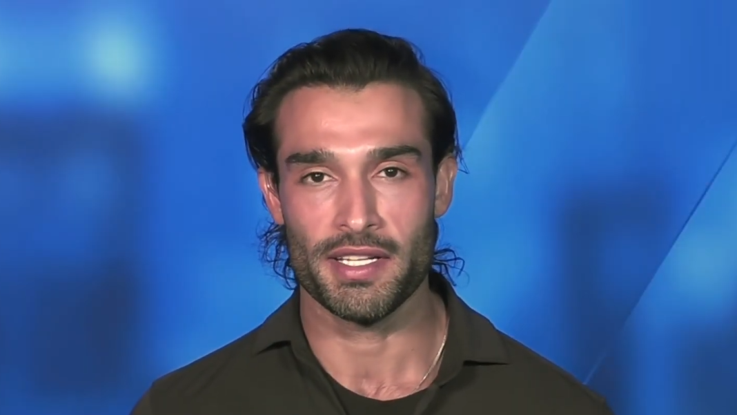 Sam Asghari speaks in from of a blue screen.