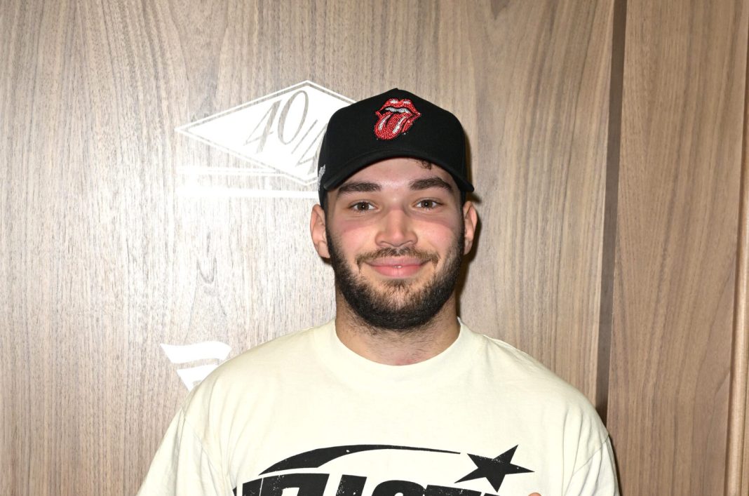 Adin Ross walks the blue carpet at JAY-Z