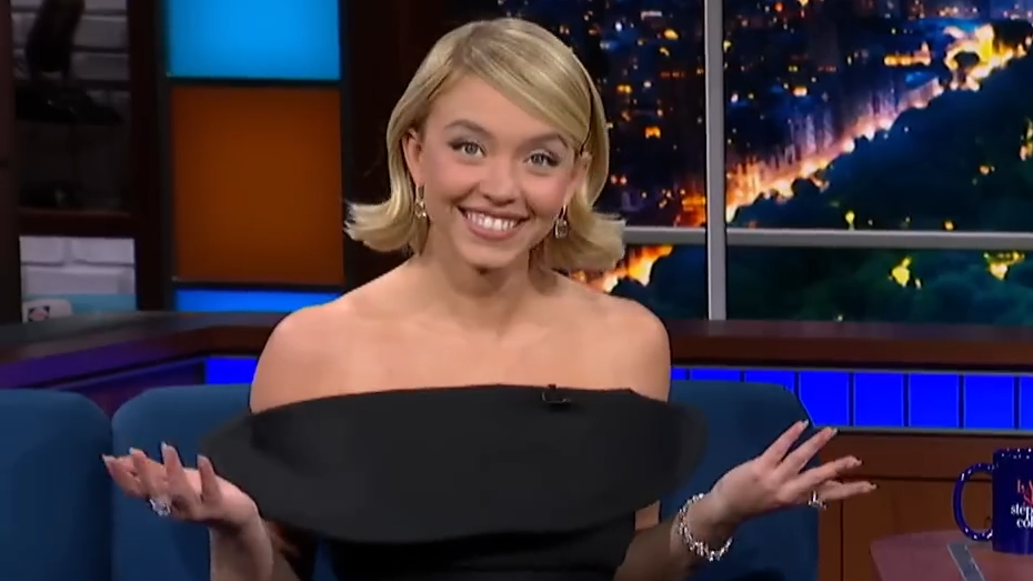Sydney Sweeney smiles and shrugs on Colbert.