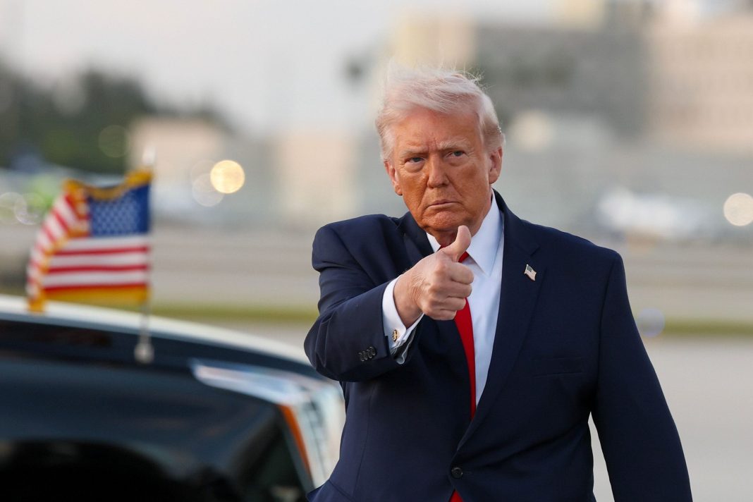 U.S. President Donald Trump waves to the media after walking off of Air Force One at Miami International Airport on April 11, 2026 in Miami, Florida. 